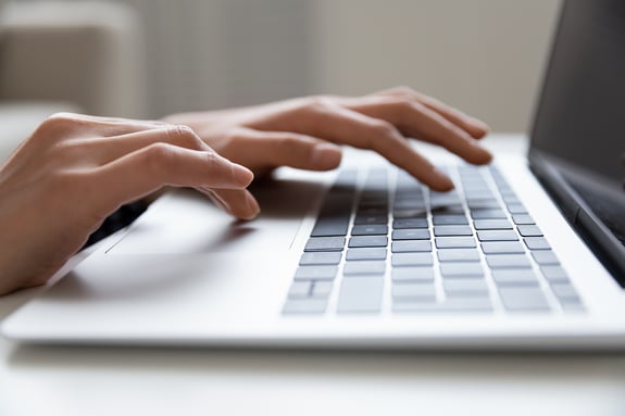 bigstock-Young-Female-Hands-Typing-On-K-408095534